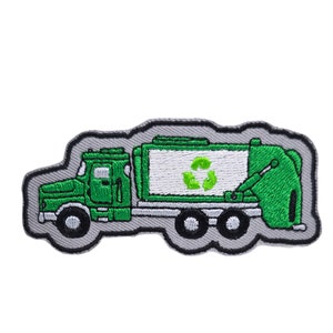 May include: Green and white embroidered patch of a recycling truck with a recycling symbol on the side.