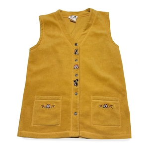 May include: Mustard yellow fleece vest with a V-neck, two front pockets, and button closure. The vest features embroidered animal designs and is a comfortable outerwear option.
