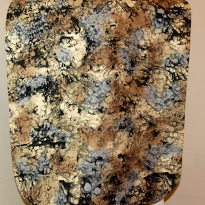 May include: A black, brown, and gray patterned bib with a rounded neckline.