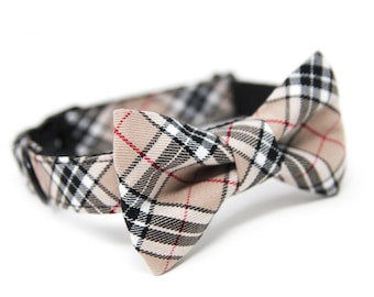 May include: A tan, black, white, and red plaid bow tie with an adjustable black elastic strap.