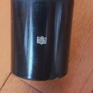 May include: A white ceramic mug with a black handle and the text "But First, Coffee" in a black, bold font. The mug is on a white surface.