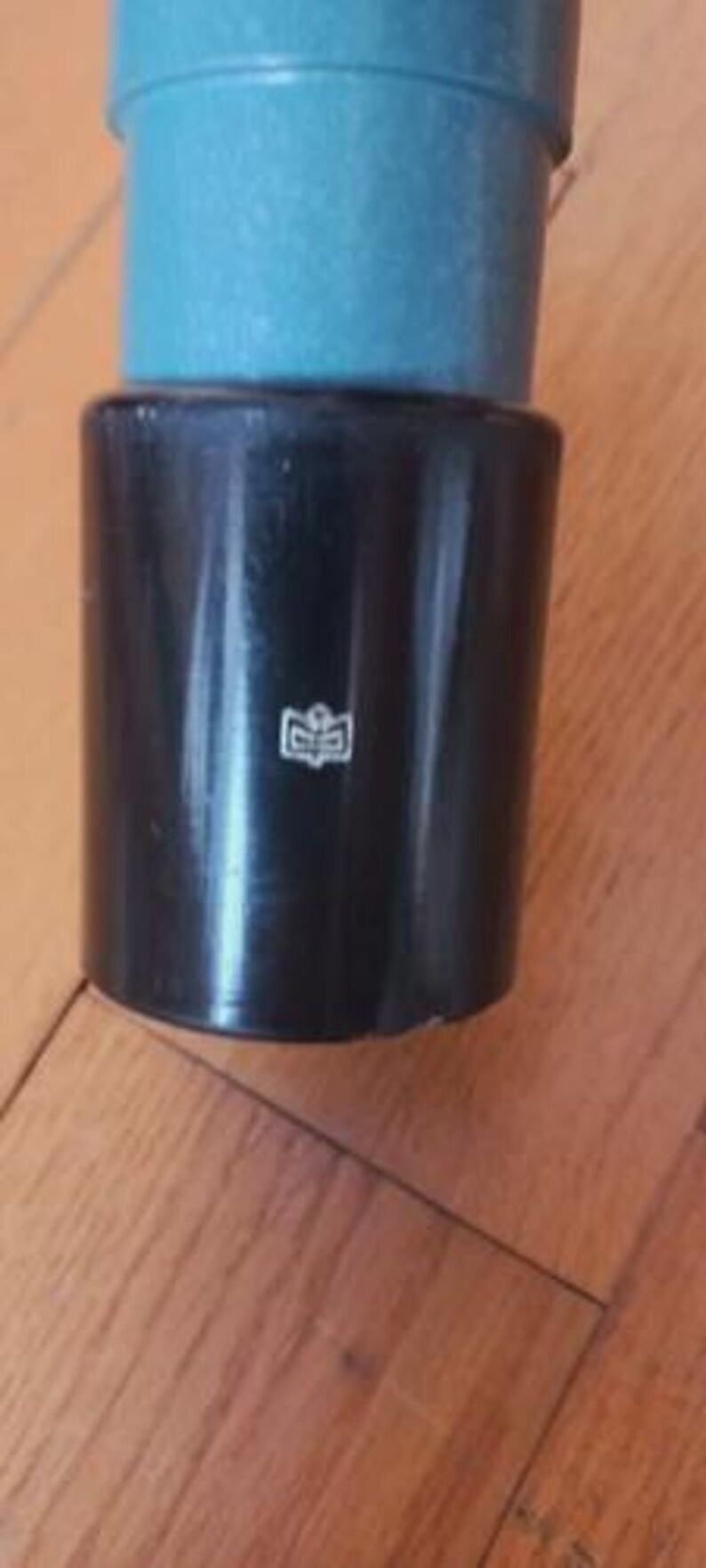 May include: A white ceramic mug with a black handle and the text "But First, Coffee" in a black, bold font. The mug is on a white surface.