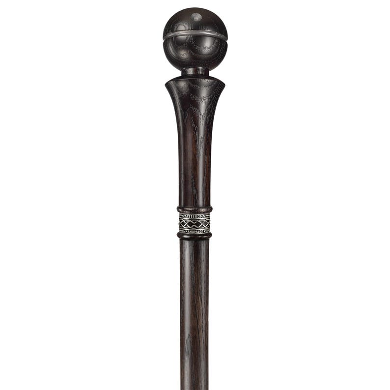 May include: A black wooden walking stick with a ball-shaped handle and a silver band.
