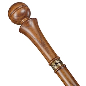 May include: A wooden walking stick with a rounded knob handle and a decorative band with a Celtic knot design.
