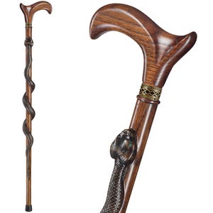 May include: A wooden walking stick with a snake design. The handle is curved and the snake is carved into the wood. The stick has a gold-coloured band around it.