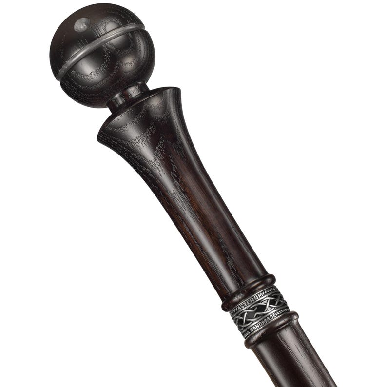 May include: A dark wood walking stick with a silver band and a round, dark wood knob at the top.
