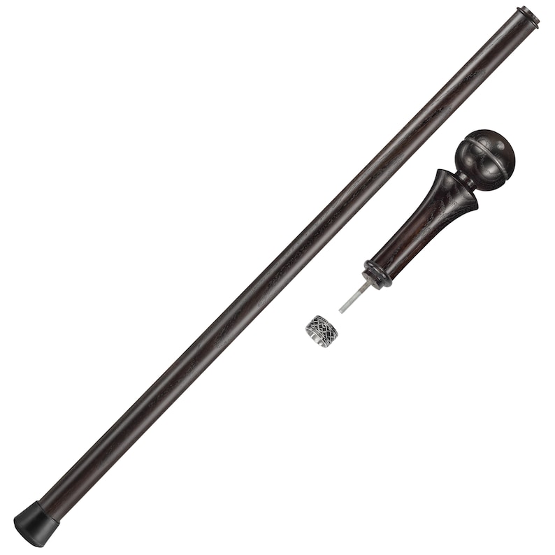 May include: A dark brown wooden walking stick with a round, decorative knob on the top. The stick has a black rubber tip on the bottom.