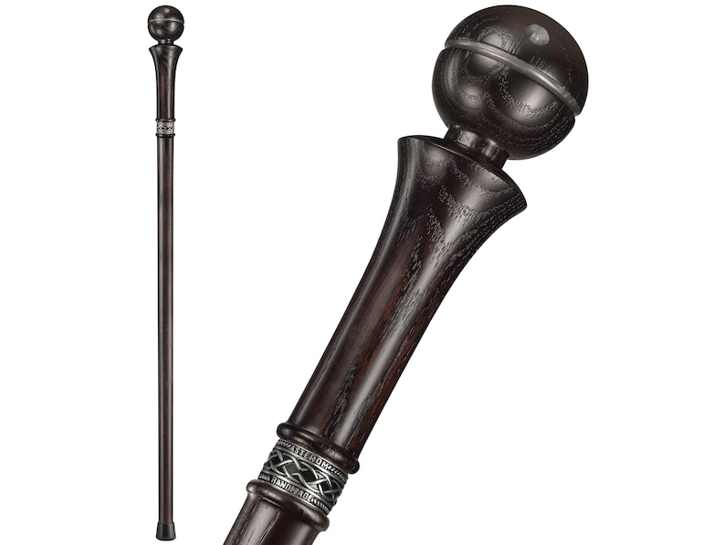 May include: A dark brown wooden walking stick with a silver band and a round, dark brown knob at the top.