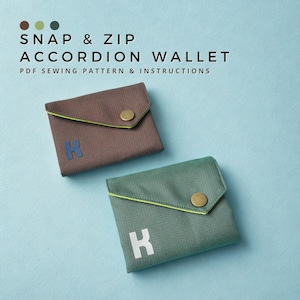 May include: Two accordion wallets with snap closures and a textured fabric finish. The brown wallet features a blue letter K, while the green wallet features a white letter K. Text reads: SNAP & ZIP ACCORDION WALLET PDF SEWING PATTERN & INSTRUCTIONS.