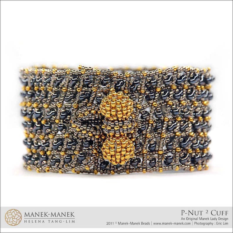 May include: A black and gold beaded bracelet with a geometric design. The bracelet is made with small, round beads and has a textured surface. The bracelet is called "P-Nut 2 Cuff" and is an original Manek Lady design.
