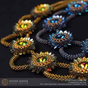 May include: A close-up of a beaded necklace with a repeating pattern of gold and blue flower-shaped designs. The necklace is made with small, iridescent beads and features a central crystal in each flower.