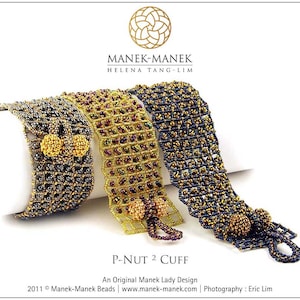 May include: Three beaded bracelets in gold, black, and purple with a gold and black bead embellishment. The bracelets are called "P-Nut 2 Cuff" and are an original Manek Lady design.
