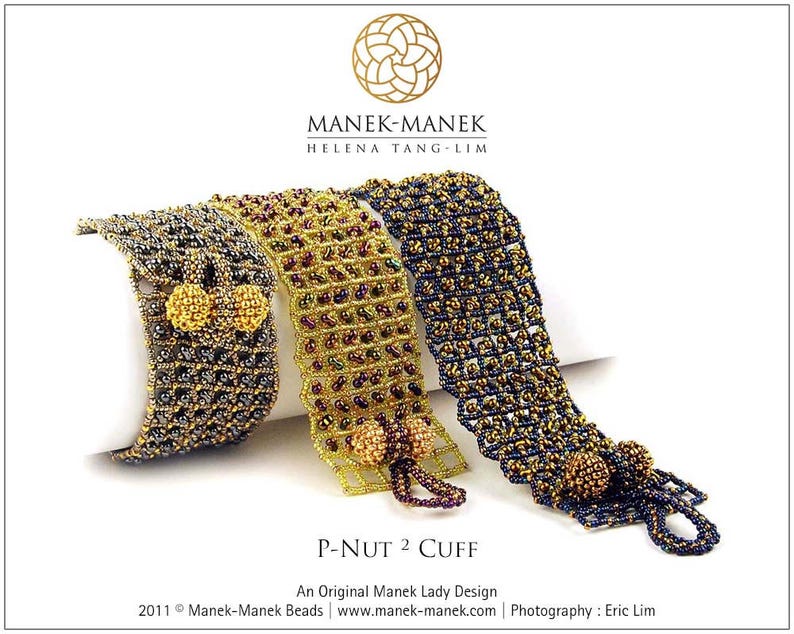May include: Three beaded bracelets in gold, black, and purple with a gold and black bead embellishment. The bracelets are called "P-Nut 2 Cuff" and are an original Manek Lady design.