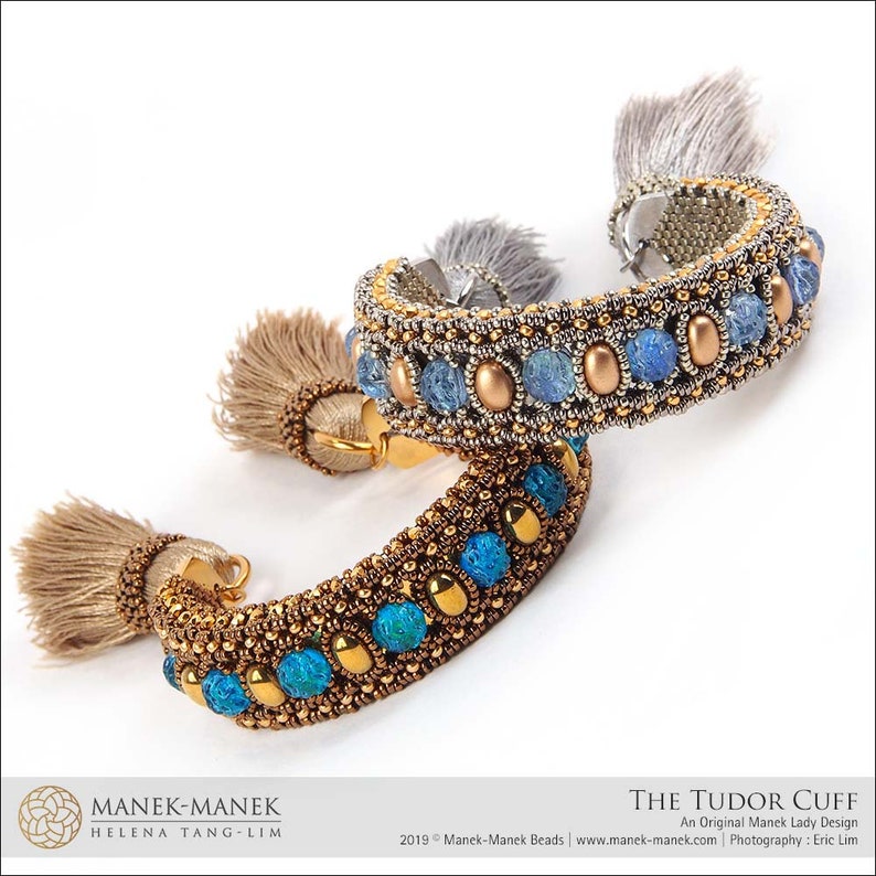 Peut inclure: Deux bracelets en perles dor&eacute;es et argent&eacute;es avec des pierres bleues et turquoise et des glands. Les bracelets sont appel&eacute;s "The Tudor Cuff" et sont un design original de Manek Lady.