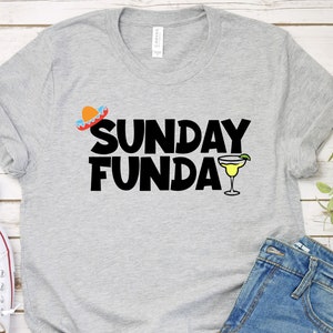 May include: Gray t-shirt with the text "SUNDAY FUNDAY" in black. A small sombrero and a margarita glass are above and below the text.