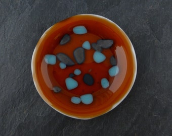 ROUND fused glass tea bag/spoon rest, mini soap dish, guitar pick tray or ring catcher Burnt Orange with Blue CONFETTI g1423