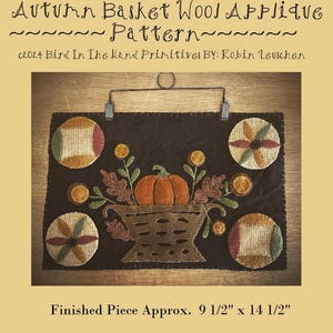 May include: A wool applique pattern for an autumn-themed basket with a pumpkin, leaves, and flowers. The finished piece measures 9 1/2 inches by 14 1/2 inches.