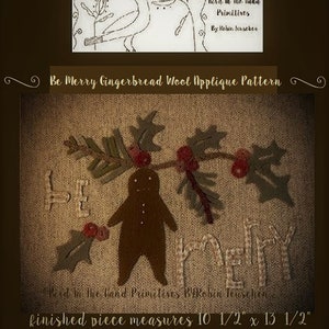 May include: A wool applique pattern for a gingerbread man with the words "Be Merry" stitched above him. The pattern is surrounded by holly leaves and berries. The finished piece measures 10 1/2 inches by 13 1/2 inches.