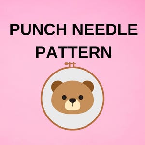 May include: A pink background with the words "PUNCH NEEDLE PATTERN" in black. A brown bear face is inside a white circle, which is inside a wooden embroidery hoop. The bear has brown ears and a black nose.