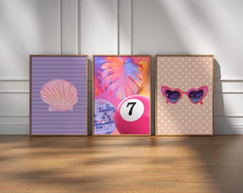 May include: Three framed prints with a pink and purple color scheme. The left print features a pink seashell on a purple and white striped background. The middle print features a pink and blue disco ball and a pink billiard ball with the number 7 on it, against a background of pink and blue palm leaves. The right print features a pair of pink heart-shaped sunglasses with blue lenses on a pink and white polka dot background.