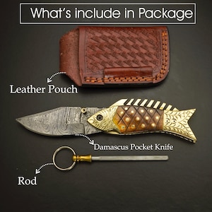 May include: A Damascus pocket knife with a fish-shaped handle, a leather pouch, and a sharpening rod are displayed on a dark surface. The knife features a patterned blade and a decorative handle with gold accents. The text "What's include in Package" is at the top.