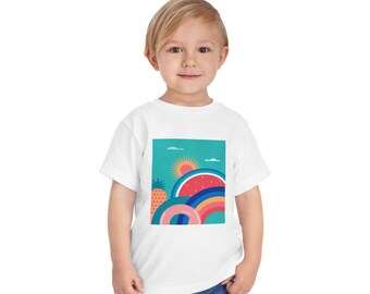 May include: White t-shirt featuring a colourful graphic design with a pineapple, watermelon, and rainbow on a turquoise background.