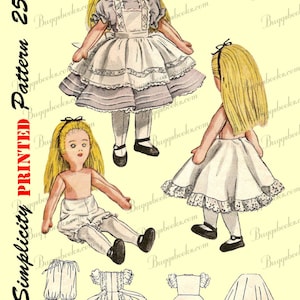 May include: A vintage Simplicity sewing pattern for a doll dress. The pattern is for a 25-cent doll dress and is printed on a yellow background. The pattern includes a dress with a lace trim, a skirt, and a pair of bloomers.