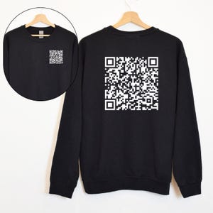 May include: Black sweatshirt with a white QR code printed on the back. The sweatshirt has a crew neck and long sleeves.
