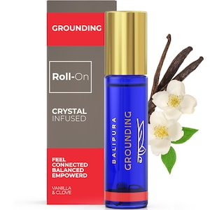 May include: A blue roll-on bottle with a gold lid and a red bottom. The bottle is labeled "GROUNDING" and "BALIPURA". The bottle is surrounded by vanilla beans and white jasmine flowers. The text on the box reads "GROUNDING", "Roll-On", "CRYSTAL INFUSED", "FEEL CONNECTED BALANCED EMPOWERD", "VANILLA & CLOVE".