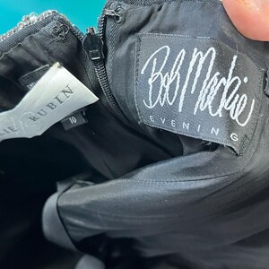 May include: A black skirt with a white label that says "Julie Rublin" and a white label that says "Bob Mackie Evening".