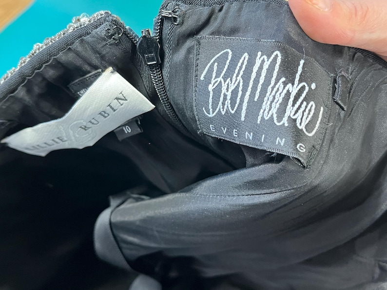 May include: A black skirt with a white label that says "Julie Rublin" and a white label that says "Bob Mackie Evening".