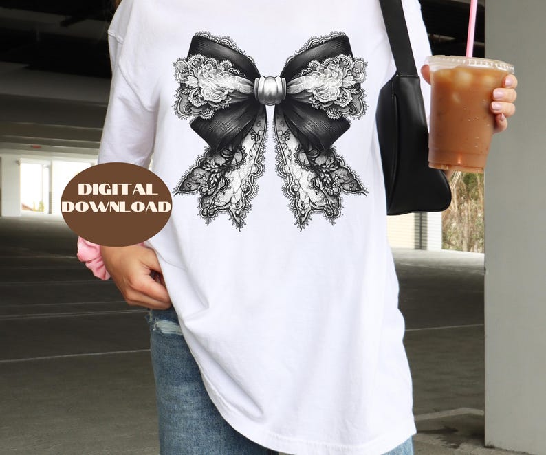 May include: A white t-shirt featuring a black and white lace bow design.