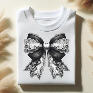 May include: White t-shirt featuring a black and white lace bow design.