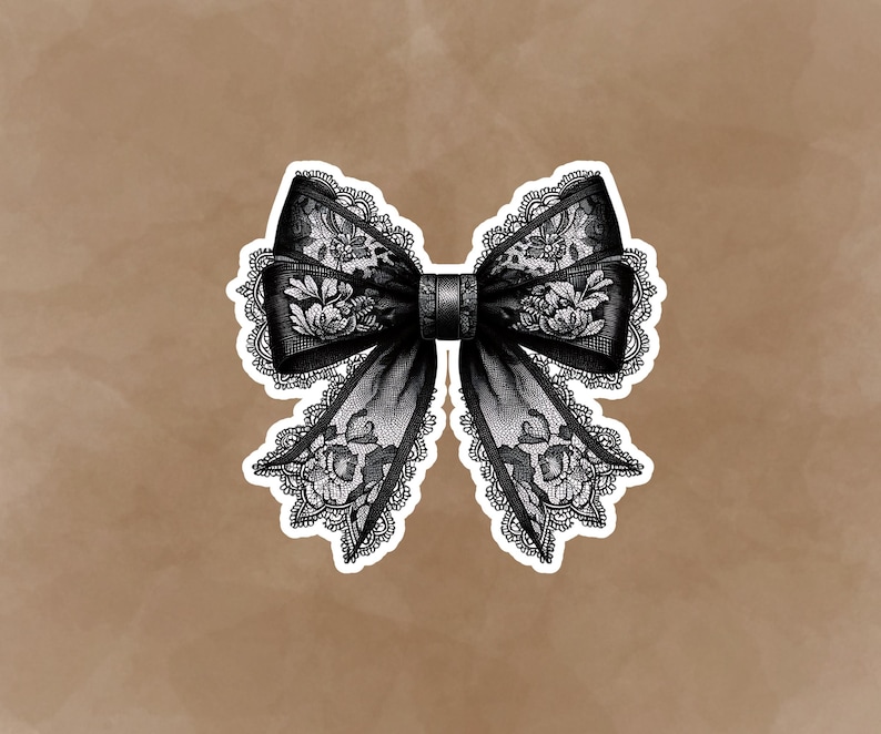 May include: A black lace bow with a white background. The bow is tied in a knot and has a decorative design.