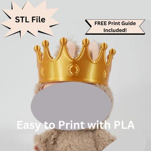 May include: A golden crown, likely 3D printed, sits atop a plush toy. The image includes text that reads "STL File" and "FREE Print Guide Included!" The text "Easy to Print with PLA" is also visible. The crown has a detailed design.