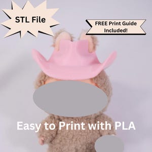 May include: A plush toy wearing a pink cowboy hat. The toy is brown and has a light pink hat. Text on the image reads "STL File" and "Easy to Print with PLA". A banner states "FREE Print Guide Included!"
