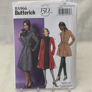 May include: A Butterick sewing pattern packet, B5966, featuring illustrations of three different coat designs. The packet includes text indicating it's for sizes 18W-24W and celebrates the 150th anniversary of Butterick.