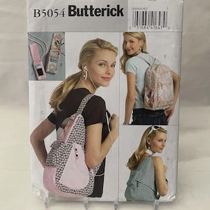 May include: A Butterick sewing pattern envelope, B5054, featuring images of women wearing and using various styles of bags. The bags include a backpack, a sling bag, and a tote bag. The envelope has a white background.