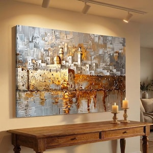 May include: A rectangular canvas wall art piece featuring a textured, impasto-style painting of a city skyline with a prominent golden dome and tower. The color palette consists of metallic gold, silver, white, and gray tones with thick paint strokes.