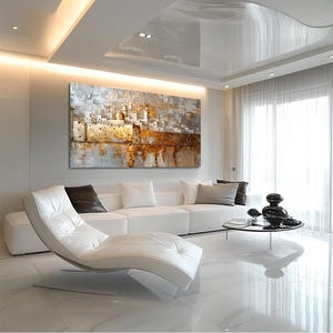 May include: A large rectangular canvas painting depicting a textured cityscape with golden and white tones. The artwork features architectural structures, domes, and walls with heavy impasto brushstrokes, creating a reflective effect on the lower portion of the composition.