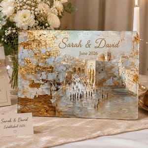 May include: A rectangular glass plaque featuring a textured gold leaf and white painted depiction of the Western Wall with people. The text Sarah & David and June 2026 is printed in gold script. A small matching card reads Sarah & David Established 2026.