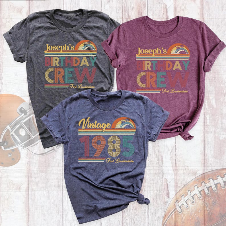 May include: Three t-shirts with a vintage 1980s theme. The shirts are in different colors: gray, maroon, and navy blue. The text on the shirts says "Joseph's Birthday Crew" and "Vintage 1985".