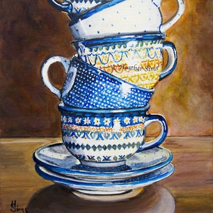 May include: A stack of four blue and white patterned teacups with a saucer, painted in a watercolor style. The cups are stacked on top of each other, with the top cup tilted slightly to the side. The cups are decorated with a variety of patterns, including polka dots, stripes, and floral designs. The saucer is also decorated with a blue and white pattern.