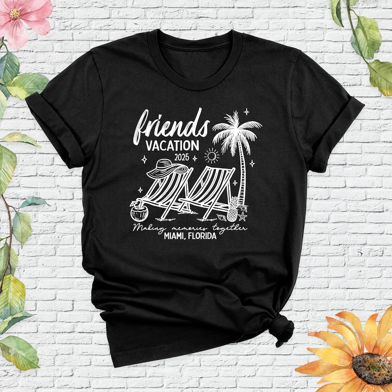 May include: Black t-shirt with a white graphic design. The design includes the words "friends vacation 2025" with beach chairs, a palm tree, and the text "Making memories together Miami, Florida."