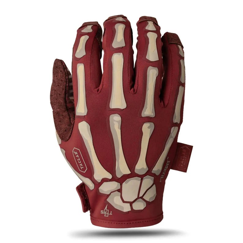 May include: A deep red tactical glove featuring a beige skeleton hand graphic printed on the back. The glove includes the text TACLAB on a small patch, the word Reaper printed on the side, and a small TTRS logo near the wrist closure.