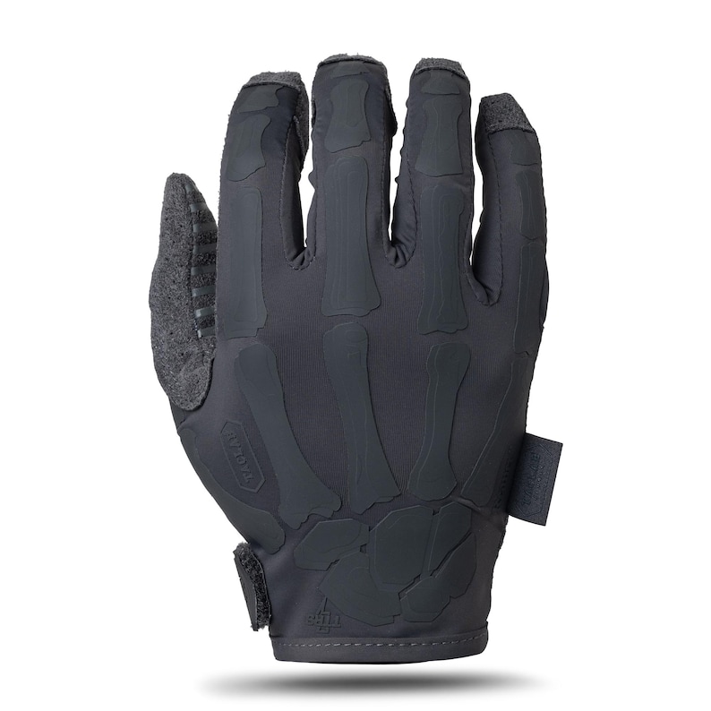 May include: A charcoal gray tactical glove featuring a matte black skeletal hand graphic printed on the back. The glove includes a textured thumb panel, a hook-and-loop wrist closure, and a small rectangular fabric tag on the side with visible text.