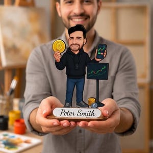 May include: A custom caricature figurine of a person wearing a black hoodie and blue jeans, holding a gold Bitcoin coin and a smartphone. The figure stands on a wooden base with the name Peter Smith printed on a white plaque, next to a stock chart.