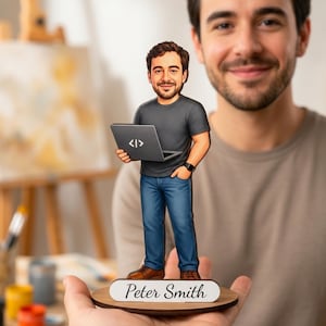 May include: A custom wooden figurine of a bearded person wearing a dark gray t-shirt, blue jeans, and brown shoes, holding a laptop with a code symbol on the lid. The figure stands on a round base with a white plaque displaying the name Peter Smith.
