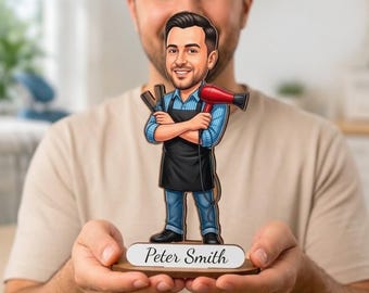 May include: A custom wooden cutout figure of a male hairdresser with a beard, wearing a blue shirt and black apron, holding a comb and a red hair dryer. The figure stands on a base with the name Peter Smith printed in black script on a white label.