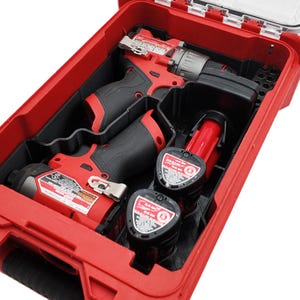 May include: A red and black power tool kit with a clear lid. The kit contains a drill, an impact driver, and two batteries. The tools are red and black, and the batteries are black with red accents. The kit is designed to hold the tools securely.